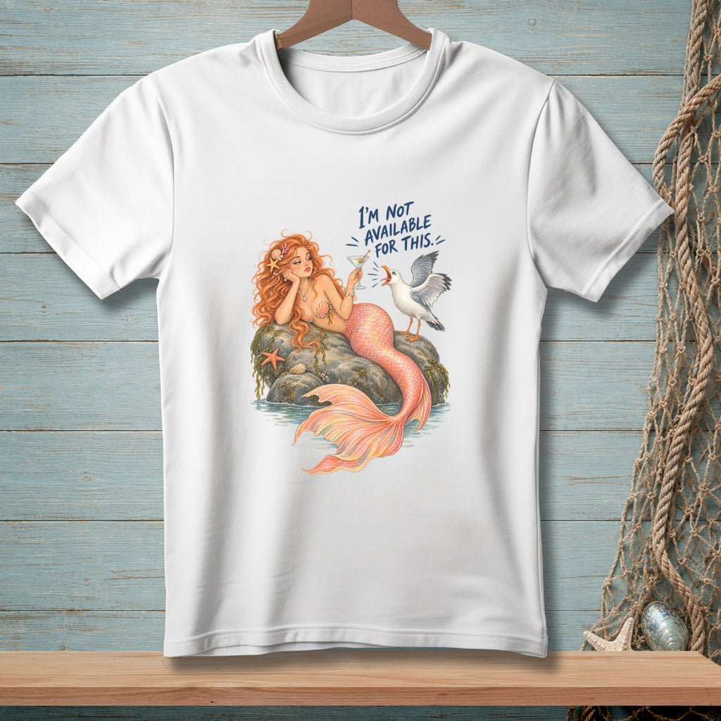 White t-shirt with a graphic of a mermaid and a seagull, reading "I'm not available for this."