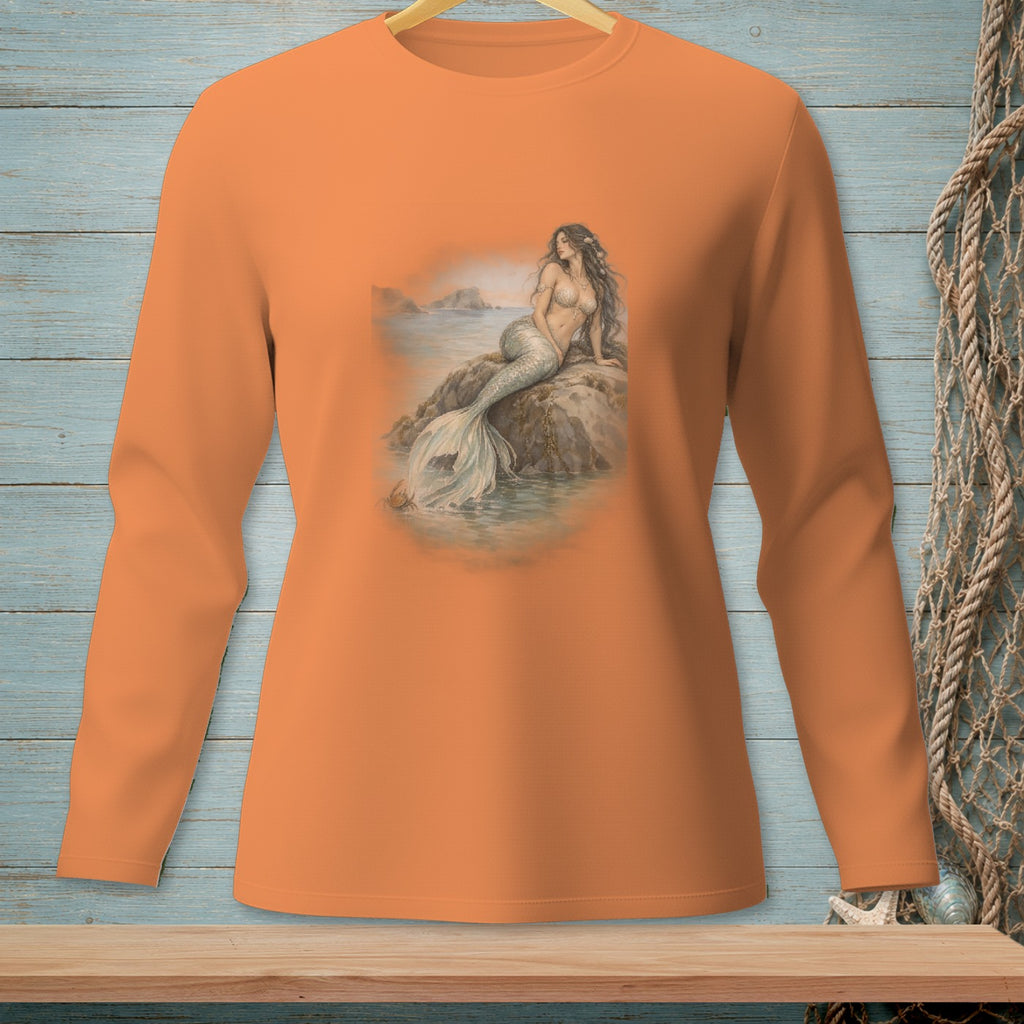 Orange long-sleeve shirt featuring a mermaid on a rock by the sea.