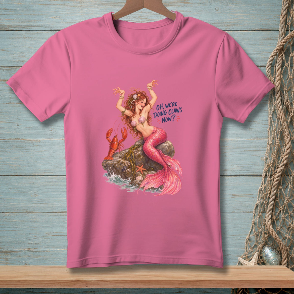 Pink t-shirt with mermaid, lobster, and text "OH, WE'RE DOING CLAWS NOW?".