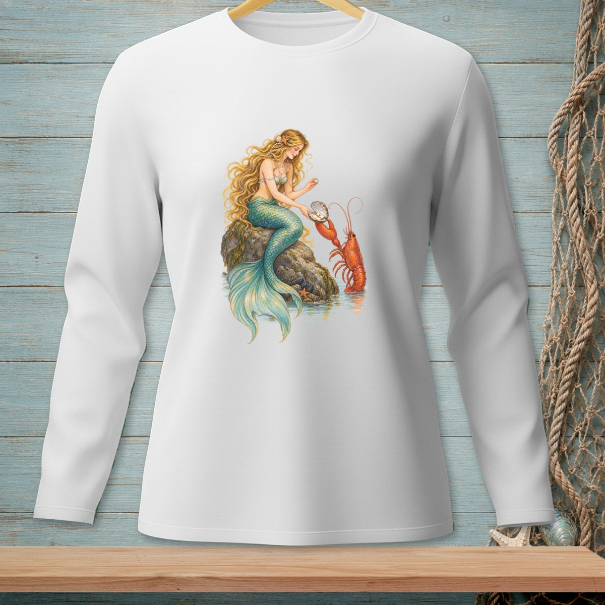 Long sleeve white shirt featuring a mermaid holding a pearl with a lobster beside her.