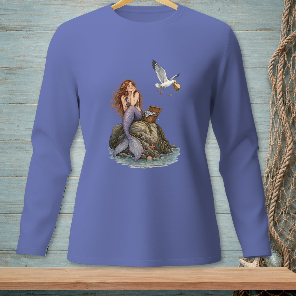 Mermaid with red hair sitting on a rock, a seagull stealing food from a picnic basket.