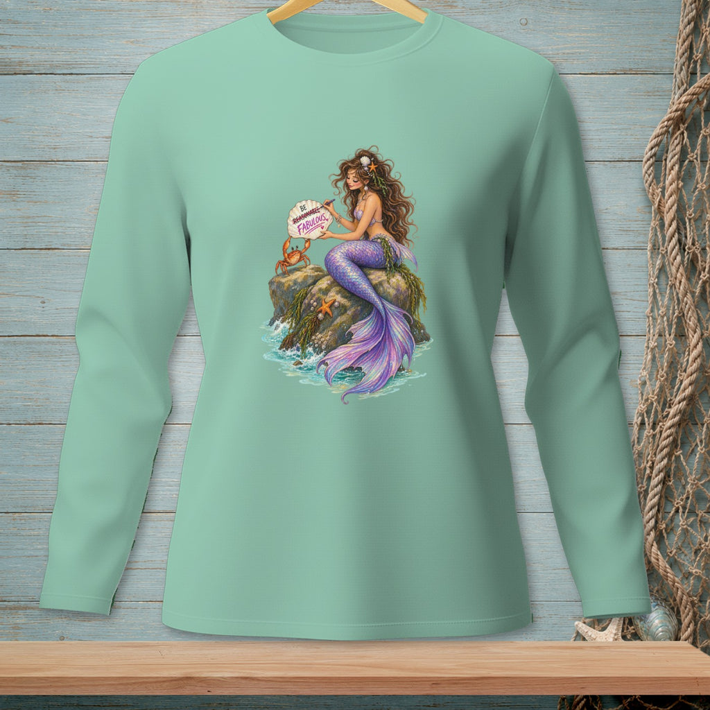 Mint green long sleeve shirt with mermaid illustration holding a sign that says "Be Reasonable. Fabulous."