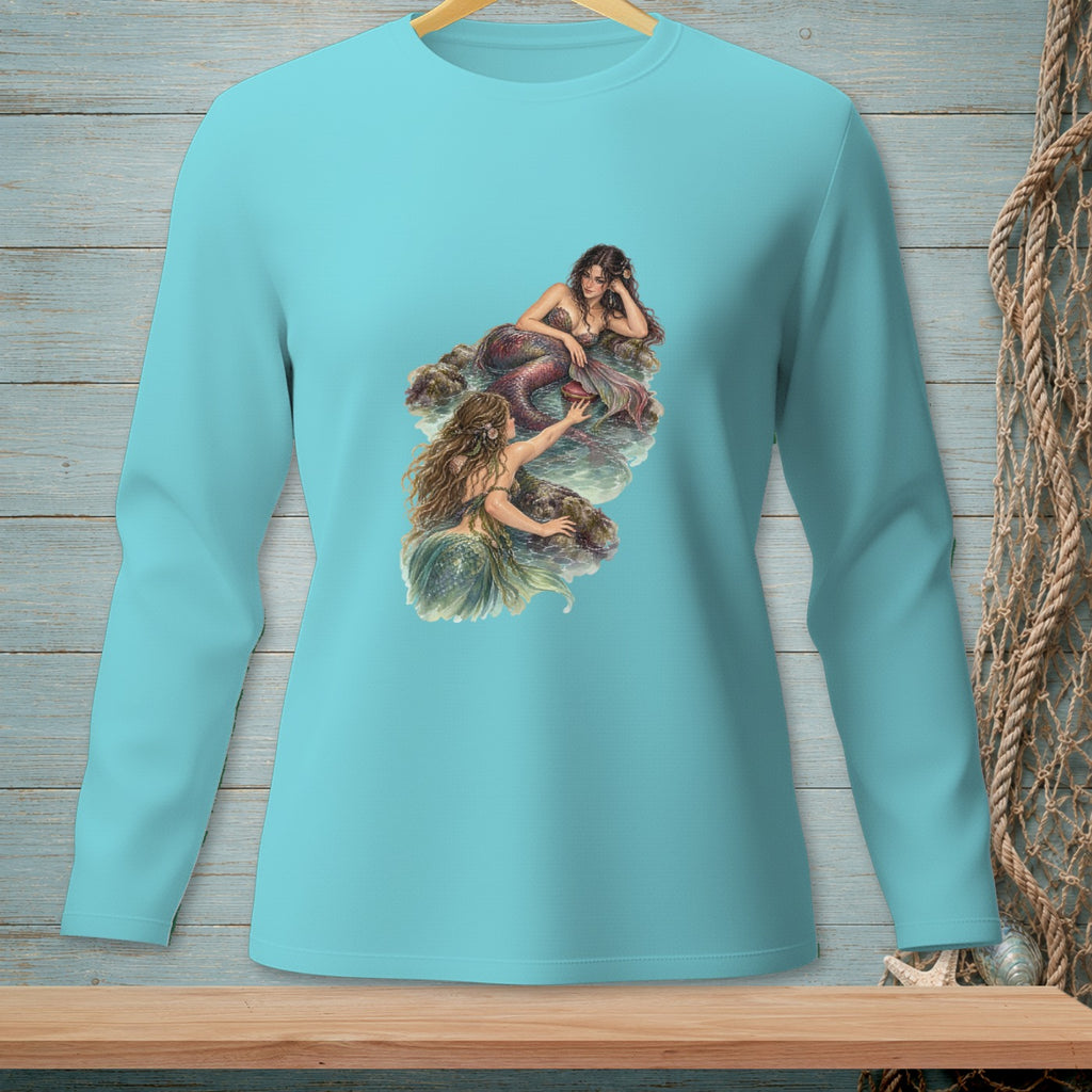 Long sleeve turquoise t-shirt with two mermaids resting on rocks.