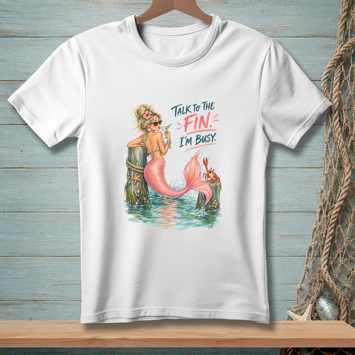 White t-shirt with mermaid graphic and text "Talk to the fin. I'm busy."