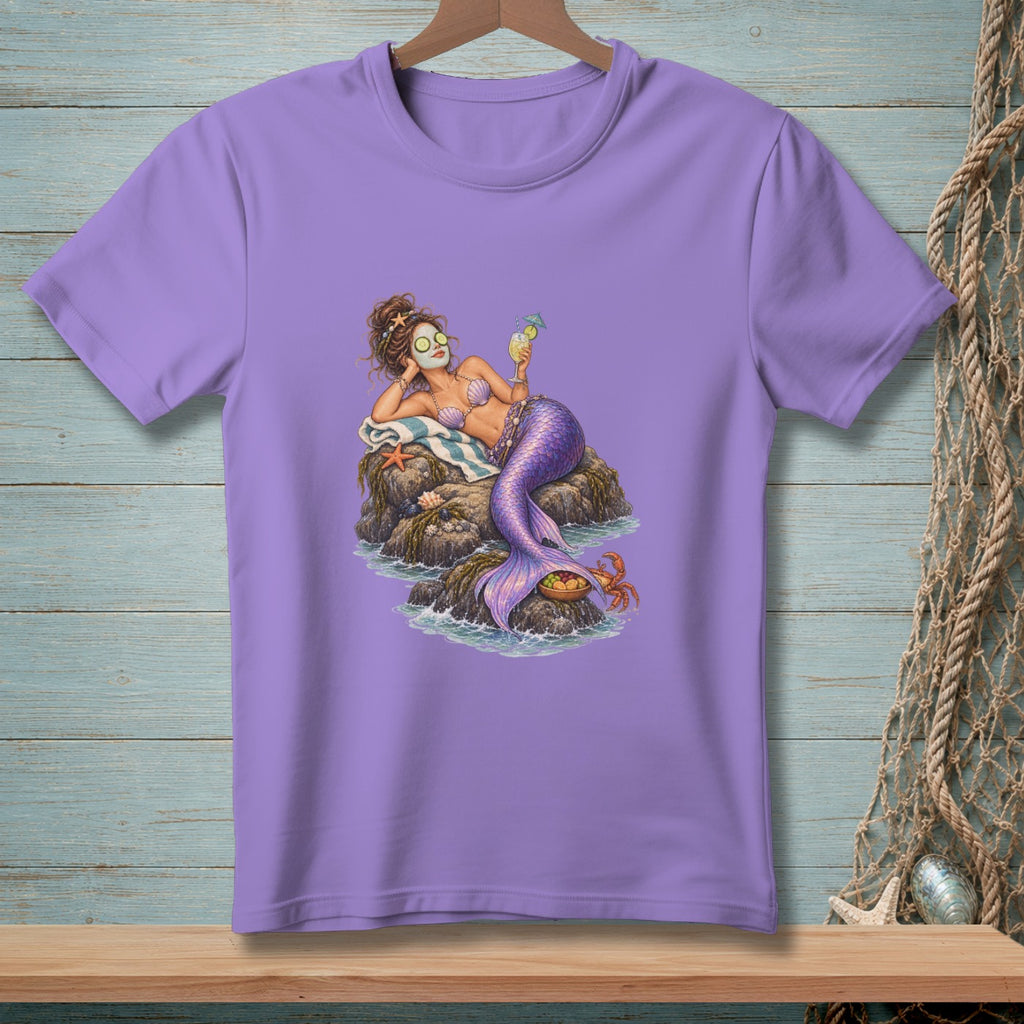 Mermaid relaxing on rocks with face mask and cocktail, purple t-shirt design.