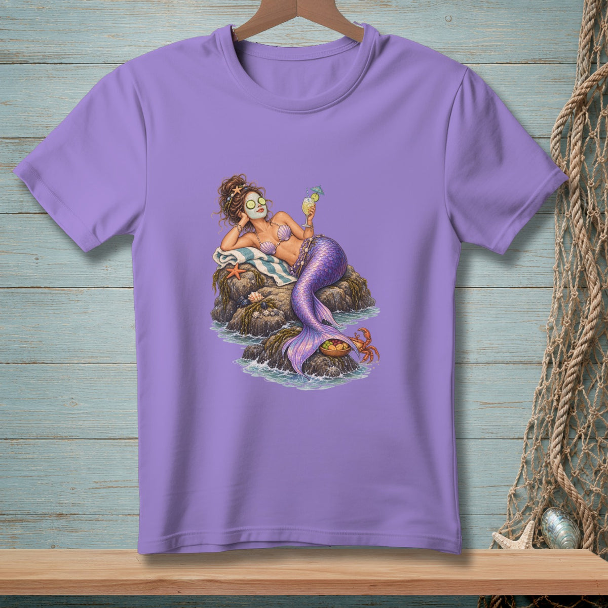 Mermaid relaxing on rocks with face mask and cocktail, purple t-shirt design.