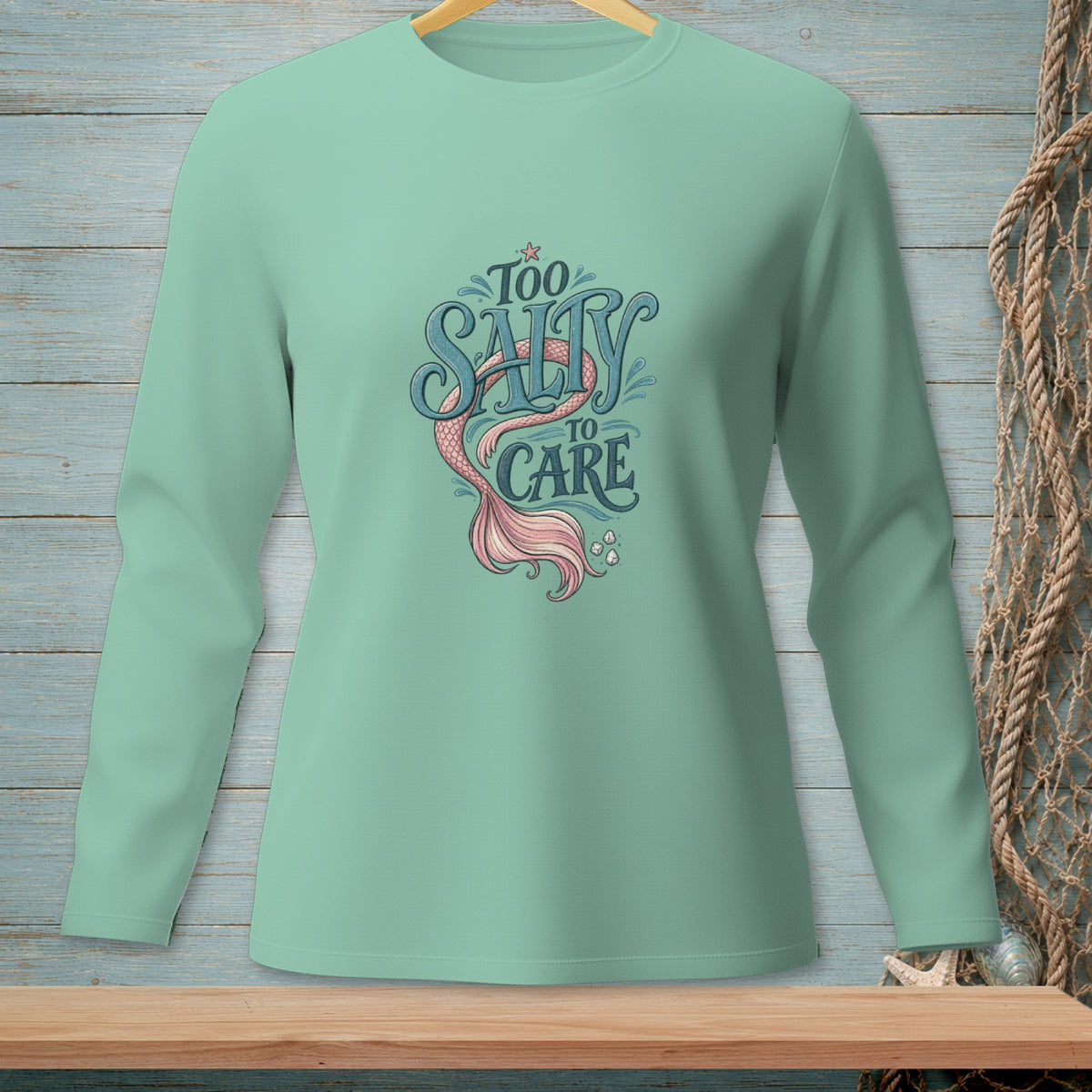 Mint green long-sleeve shirt with "Too Salty to Care" and mermaid tail graphic.