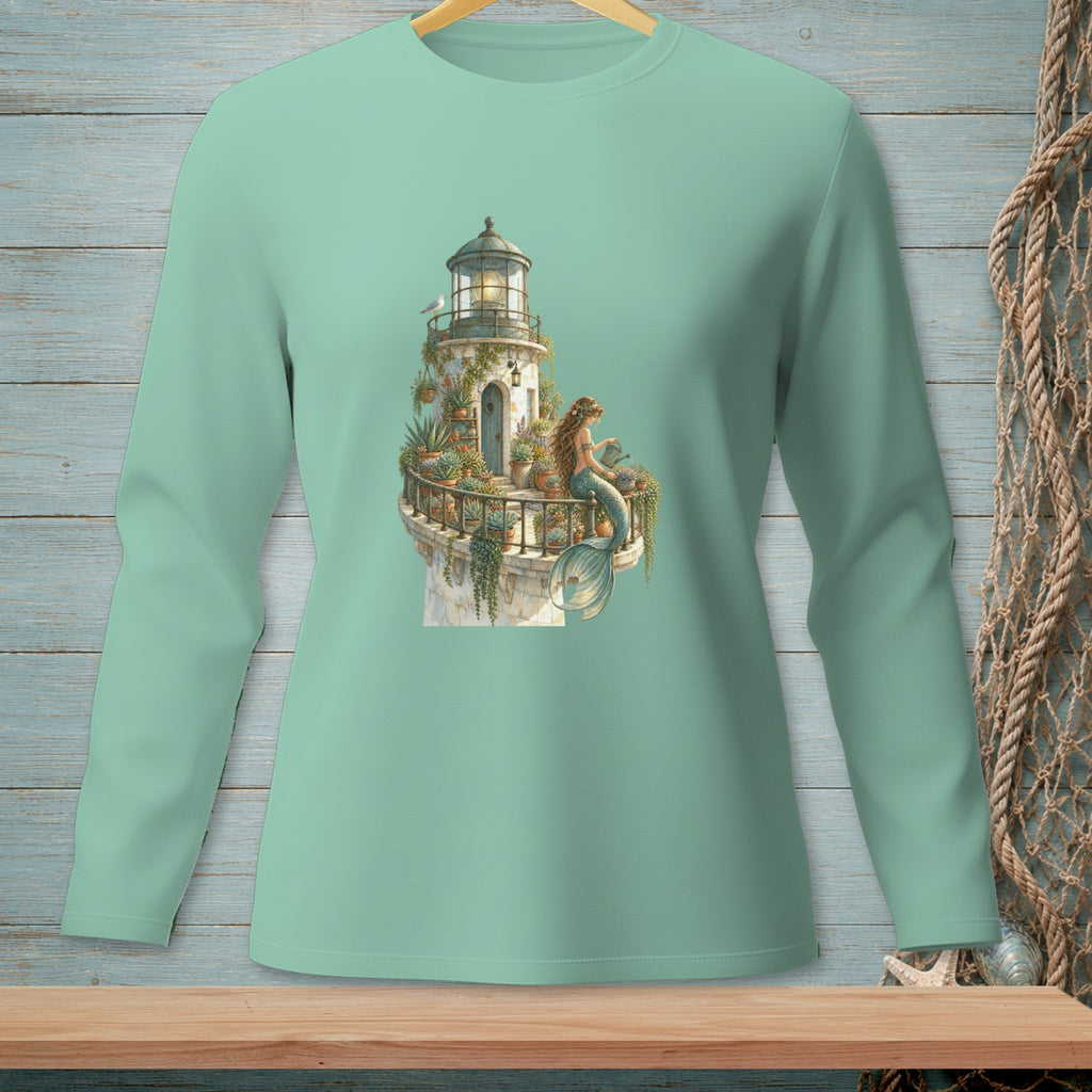 Mint green long sleeve shirt with lighthouse and mermaid illustration.