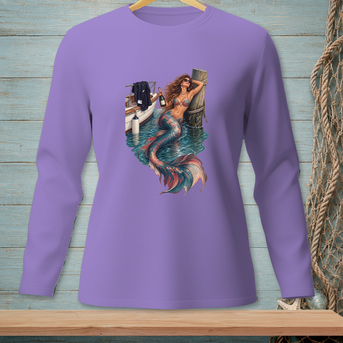 Purple long sleeve shirt with a graphic of a mermaid holding a bottle on a boat.