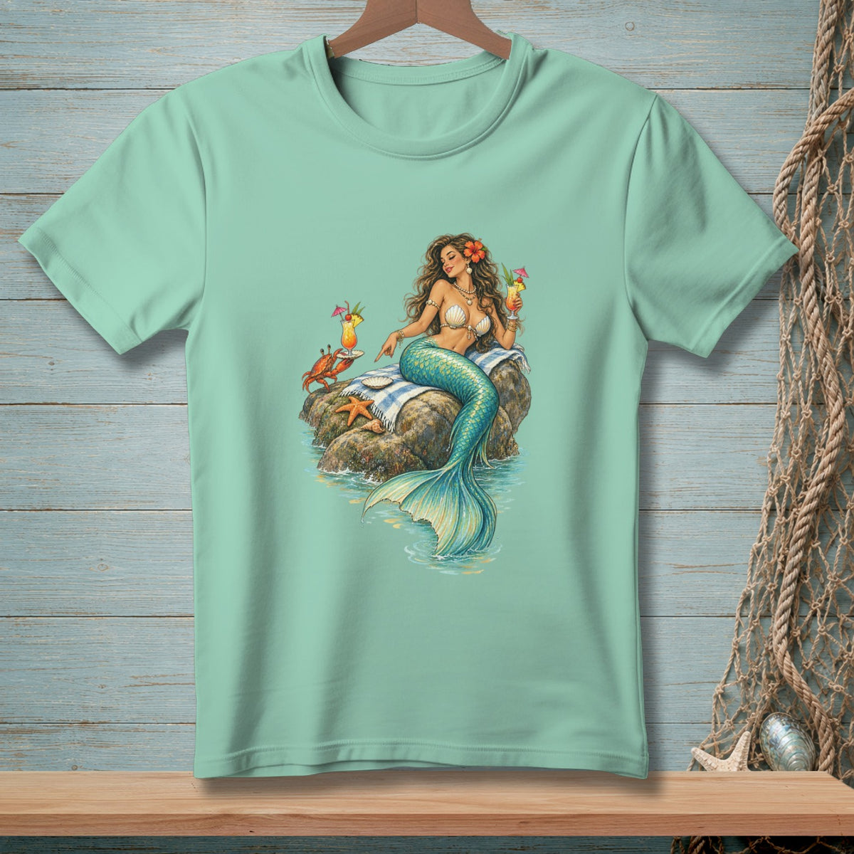 Mint t-shirt with a mermaid holding cocktails on a rock with a crab and starfish.