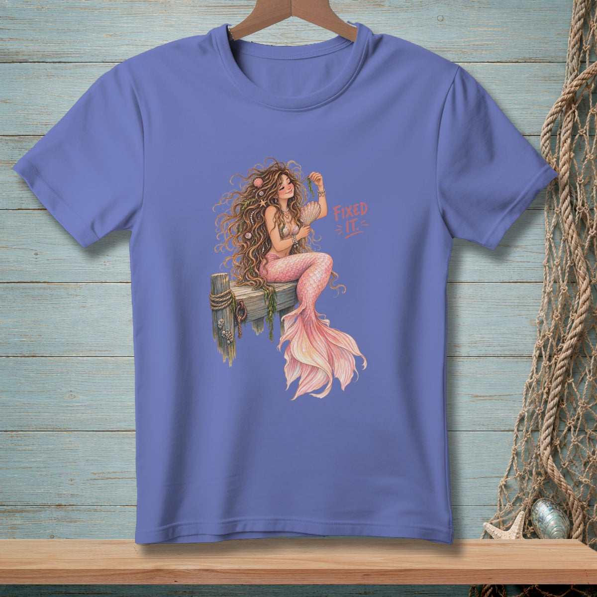 Illustration of a mermaid sitting on a wooden pier with the text "Fixed it".
