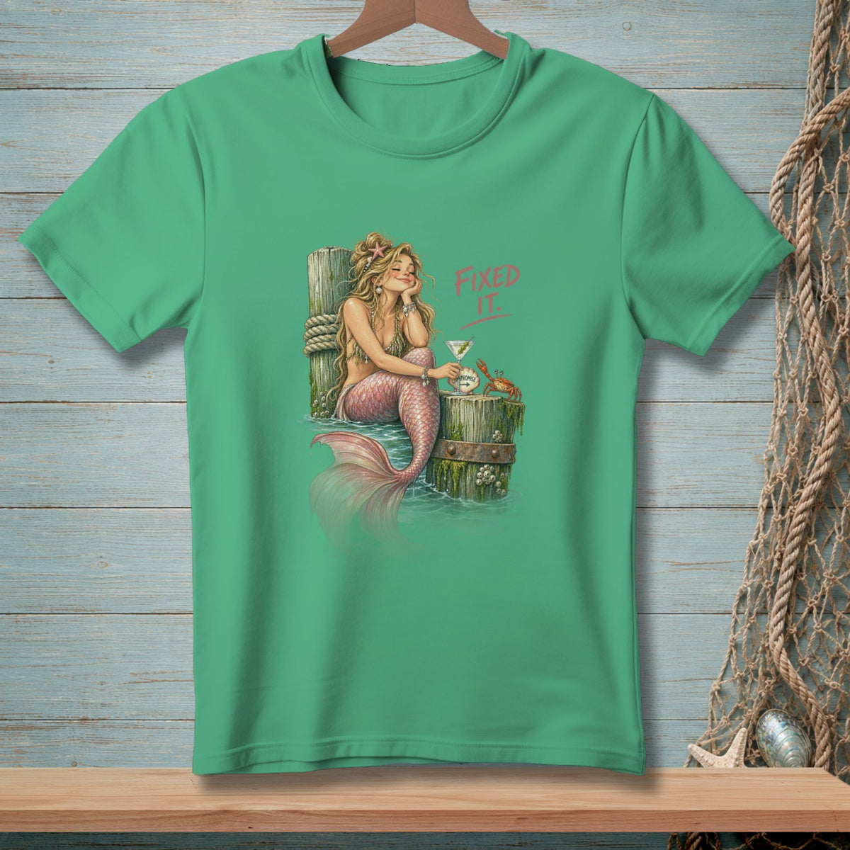 Green t-shirt with a mermaid, crab, and "Fixed It." text.
