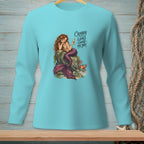 Teal long-sleeve shirt with a mermaid, crab, and the text "Crabby looks good on you."