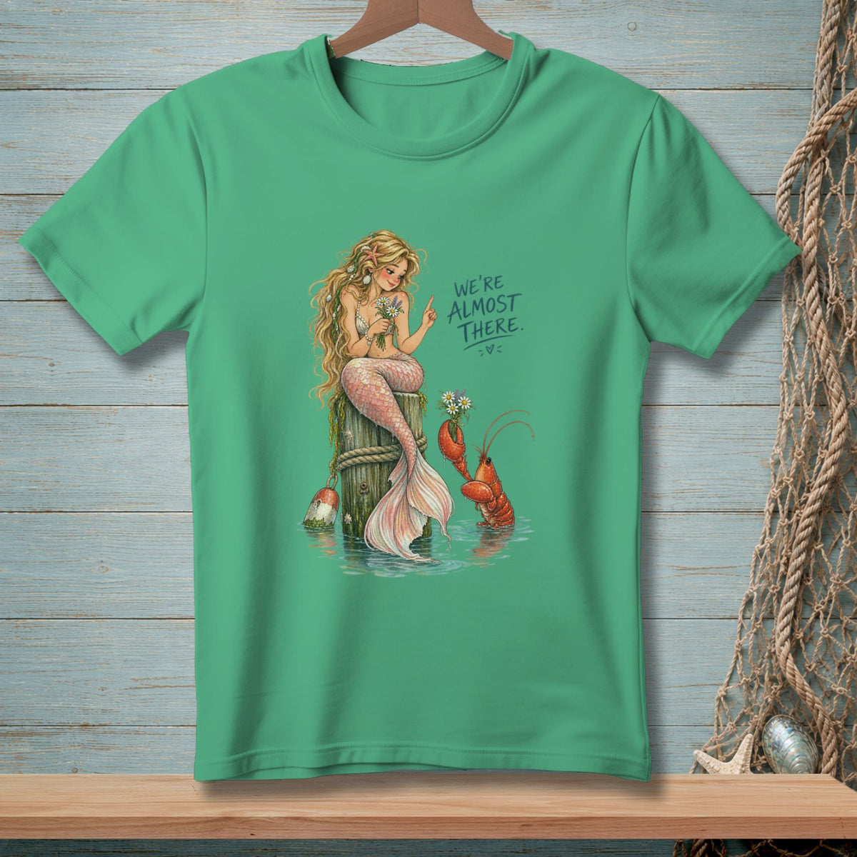 Mermaid with lobster and text "WE'RE ALMOST THERE."