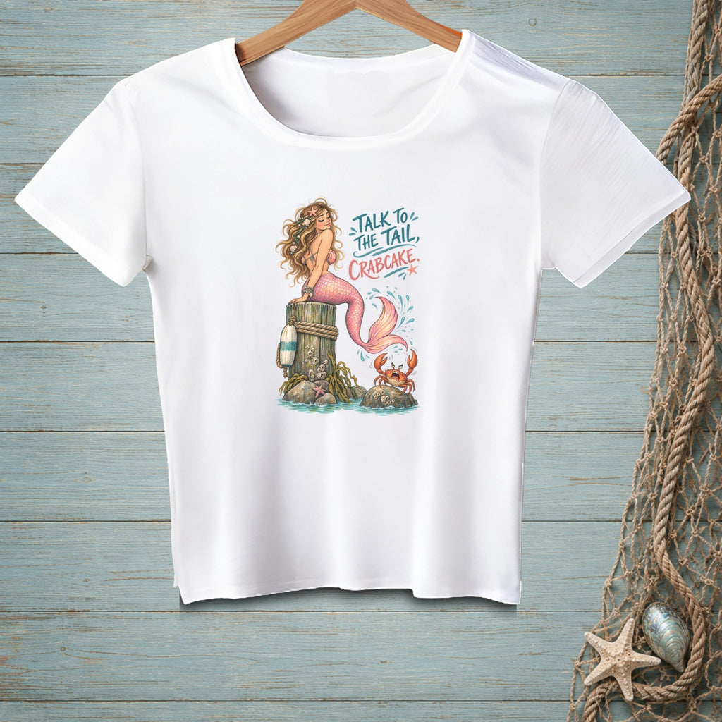 White t-shirt with mermaid, crab, and text "Talk to the tail, crabcake."