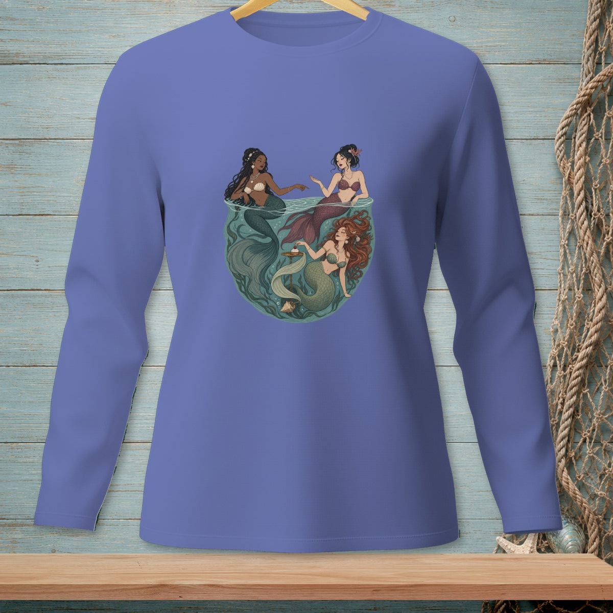 Long-sleeve shirt with a graphic of three mermaids in a circular underwater scene.