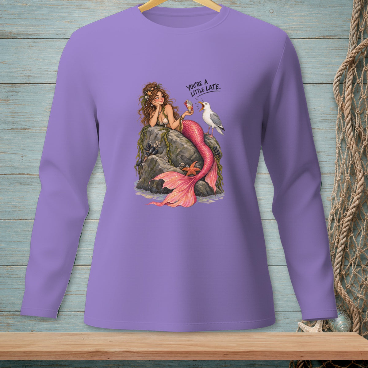 Purple long-sleeve shirt with a mermaid sitting on rocks holding ice cream, with a seagull.