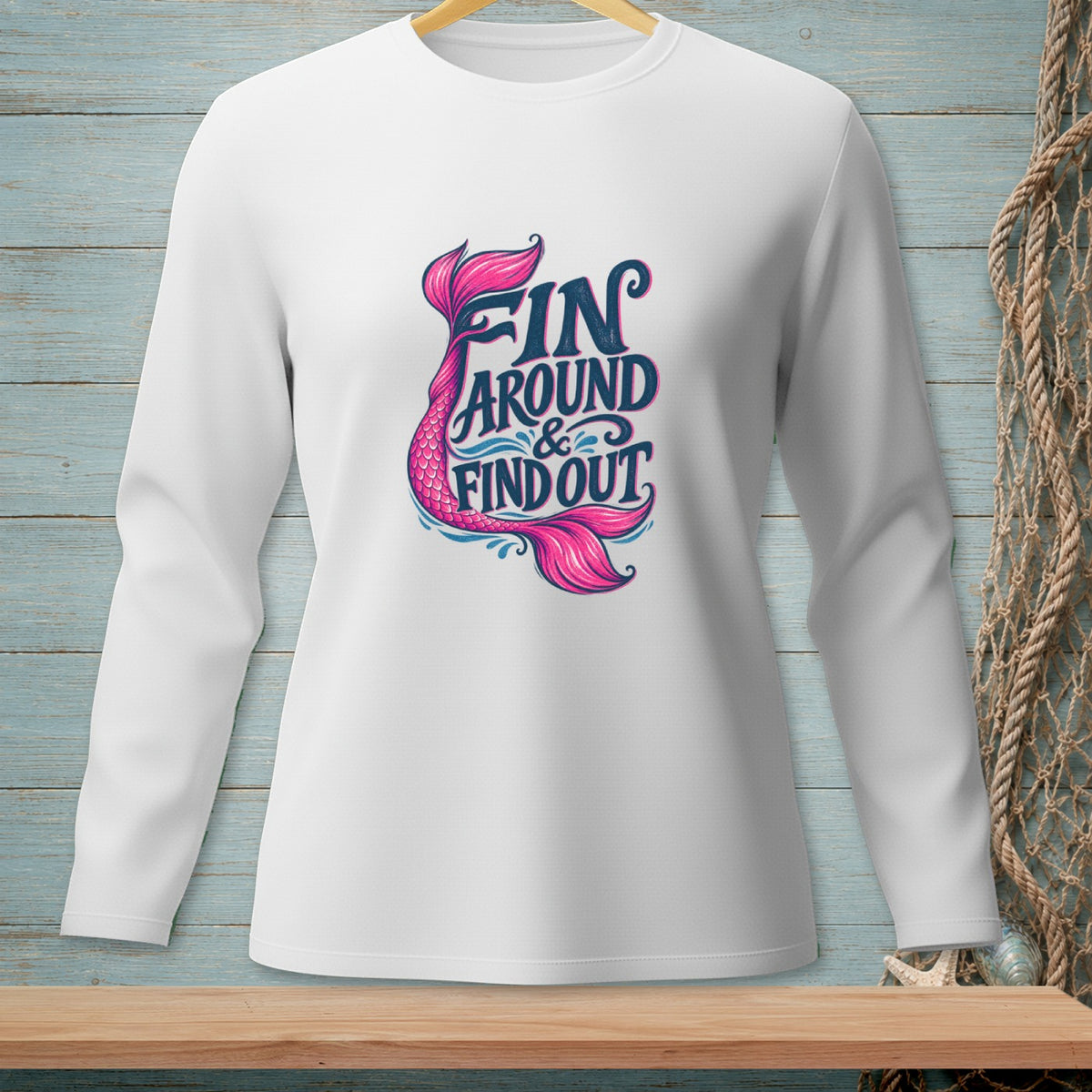 White long-sleeve shirt with pink and blue text and mermaid tail graphic.