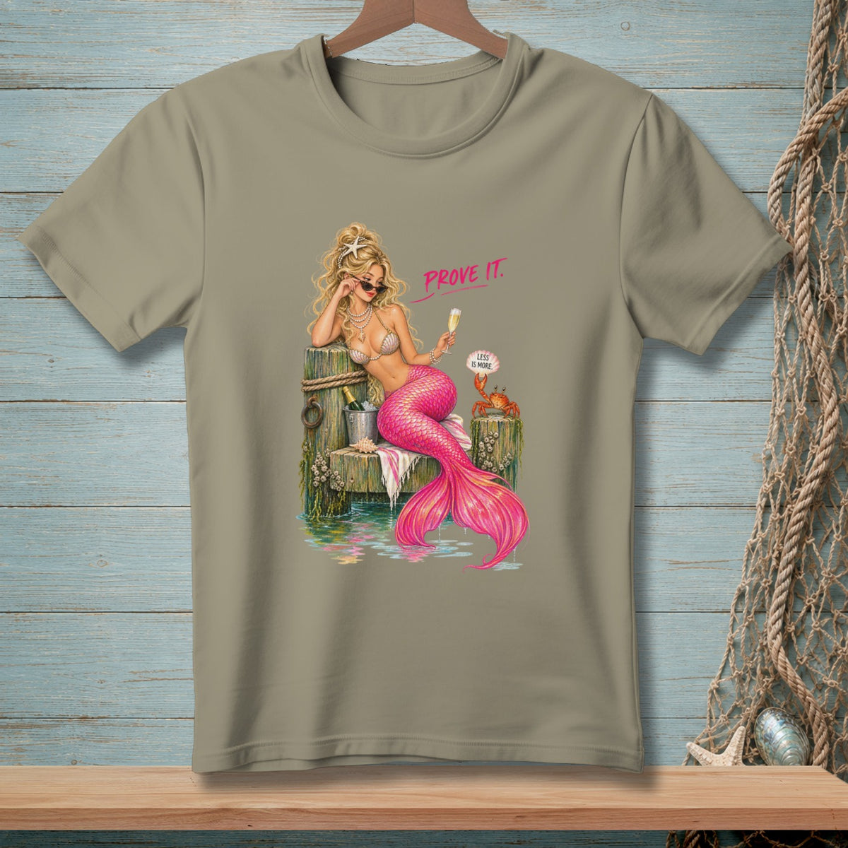 Blonde mermaid with pink tail holds champagne glass, text "PROVE IT."