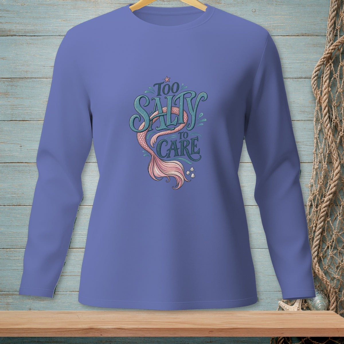 Long-sleeve shirt with "Too Salty to Care" text and mermaid tail graphic.