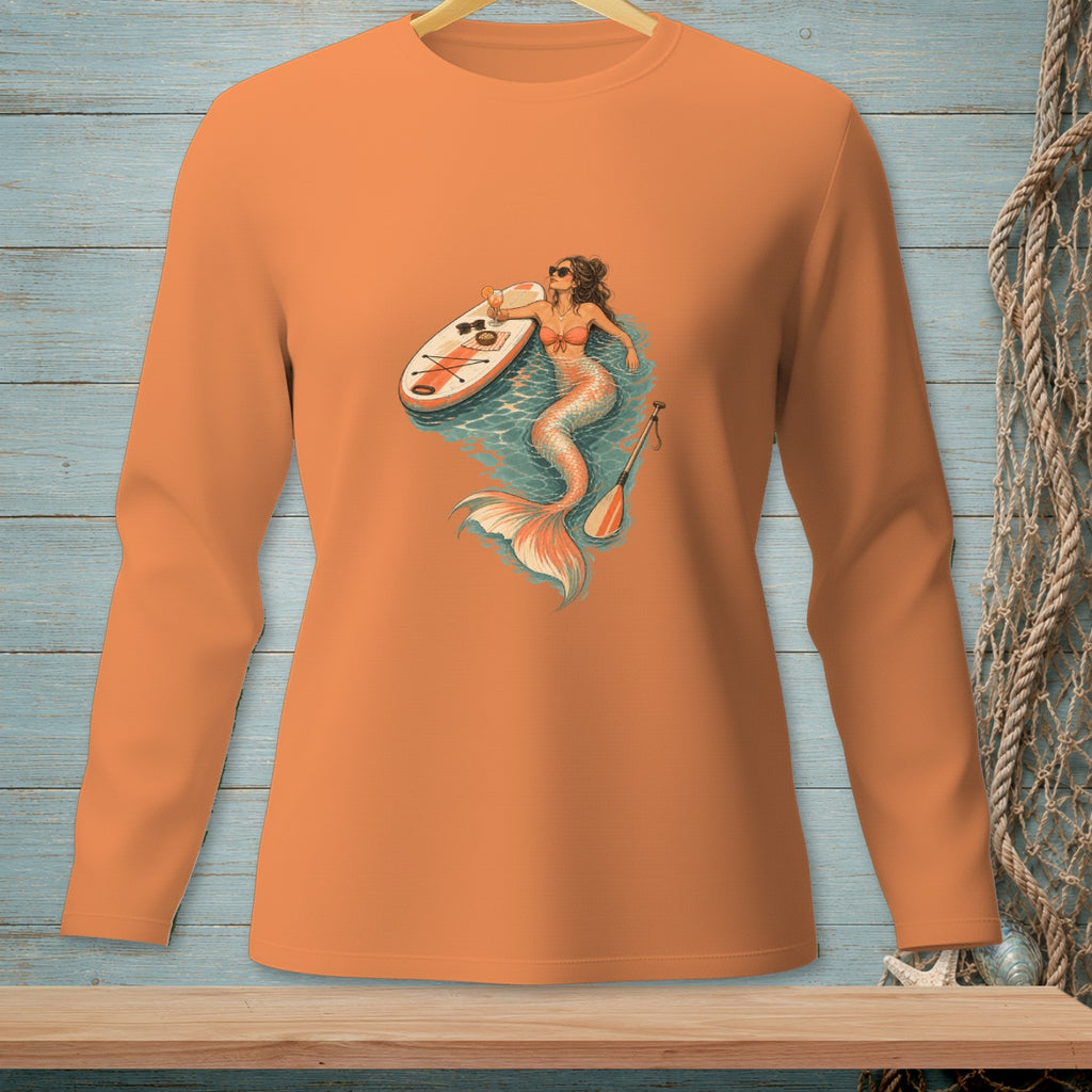 Mermaid with paddleboard and drink on orange long-sleeve shirt.