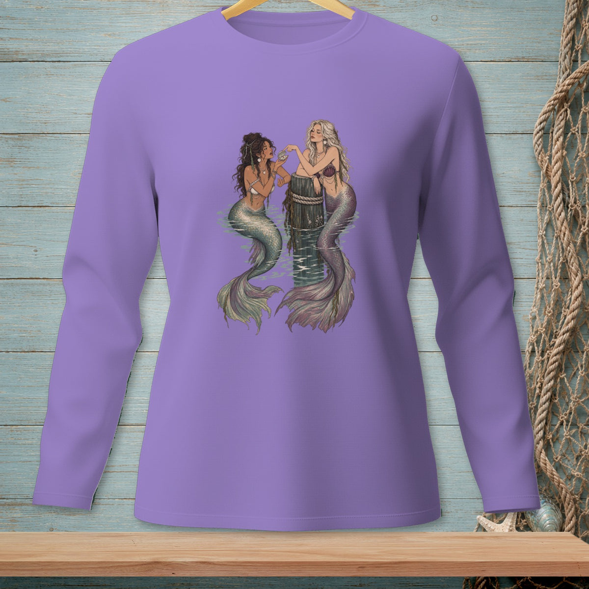 Purple long-sleeve shirt with an illustration of two mermaids on a wooden post.