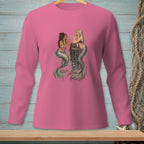 Two mermaids sit on a wooden post in the water, interacting with shells.