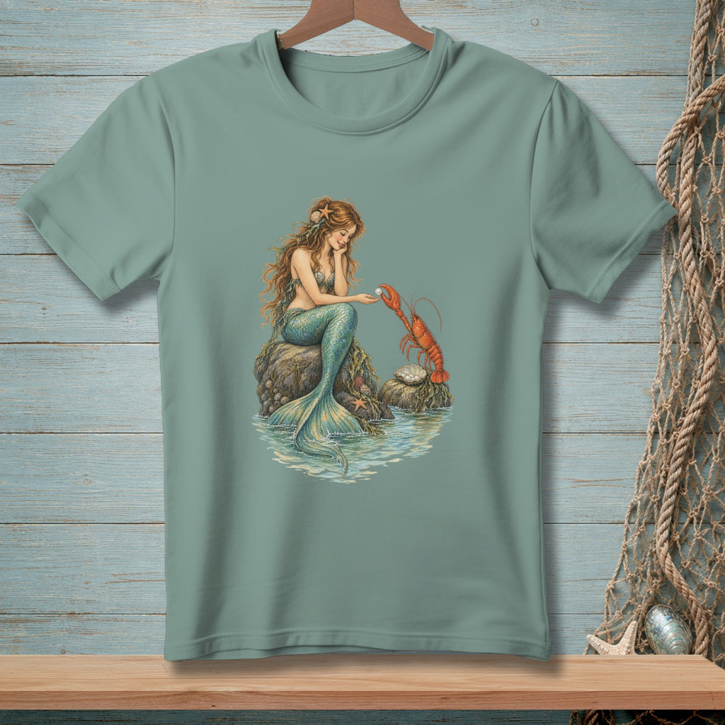 Mermaid interacting with a lobster on a rock near the water.