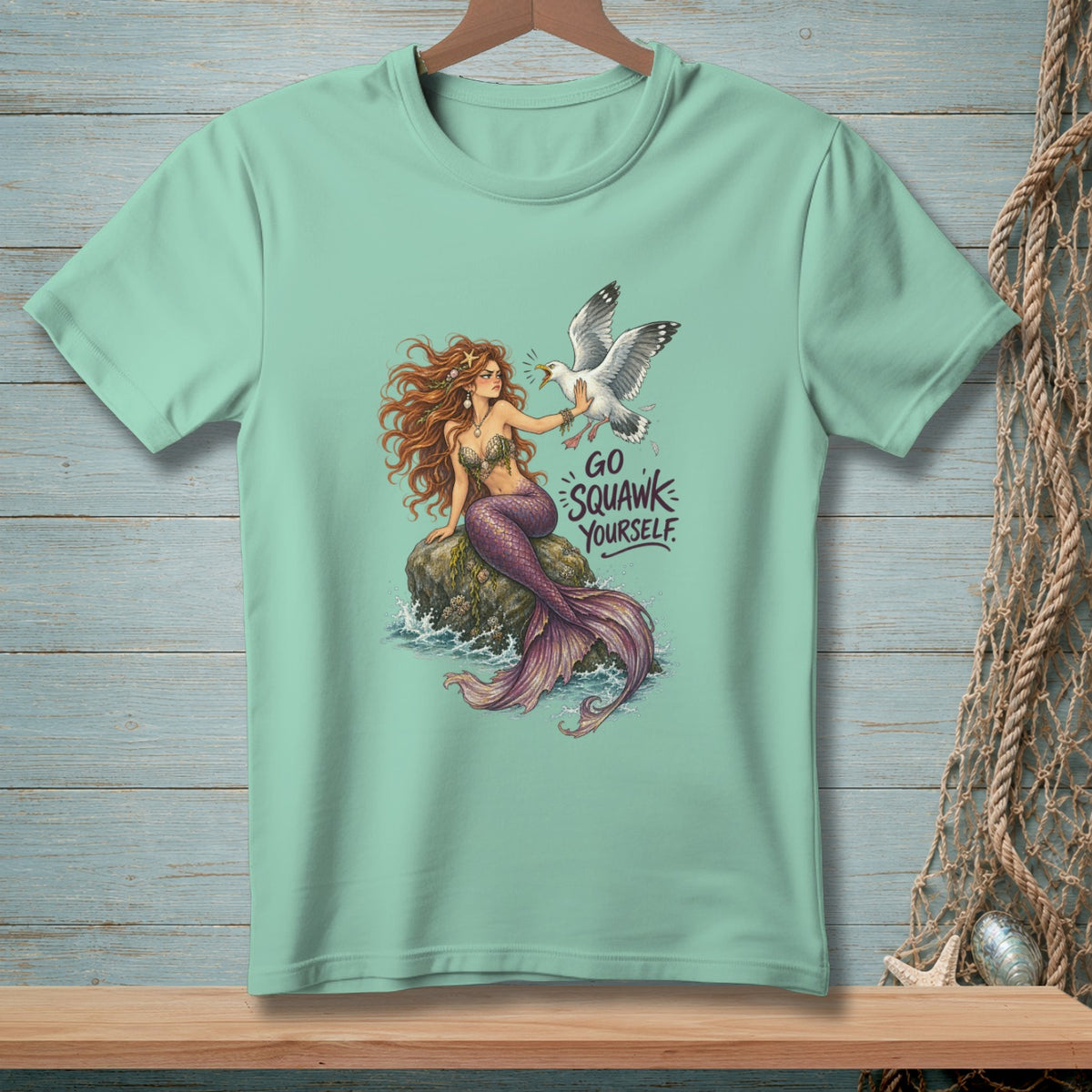 Mermaid on rock pushes away a seagull with text "Go Squawk Yourself."