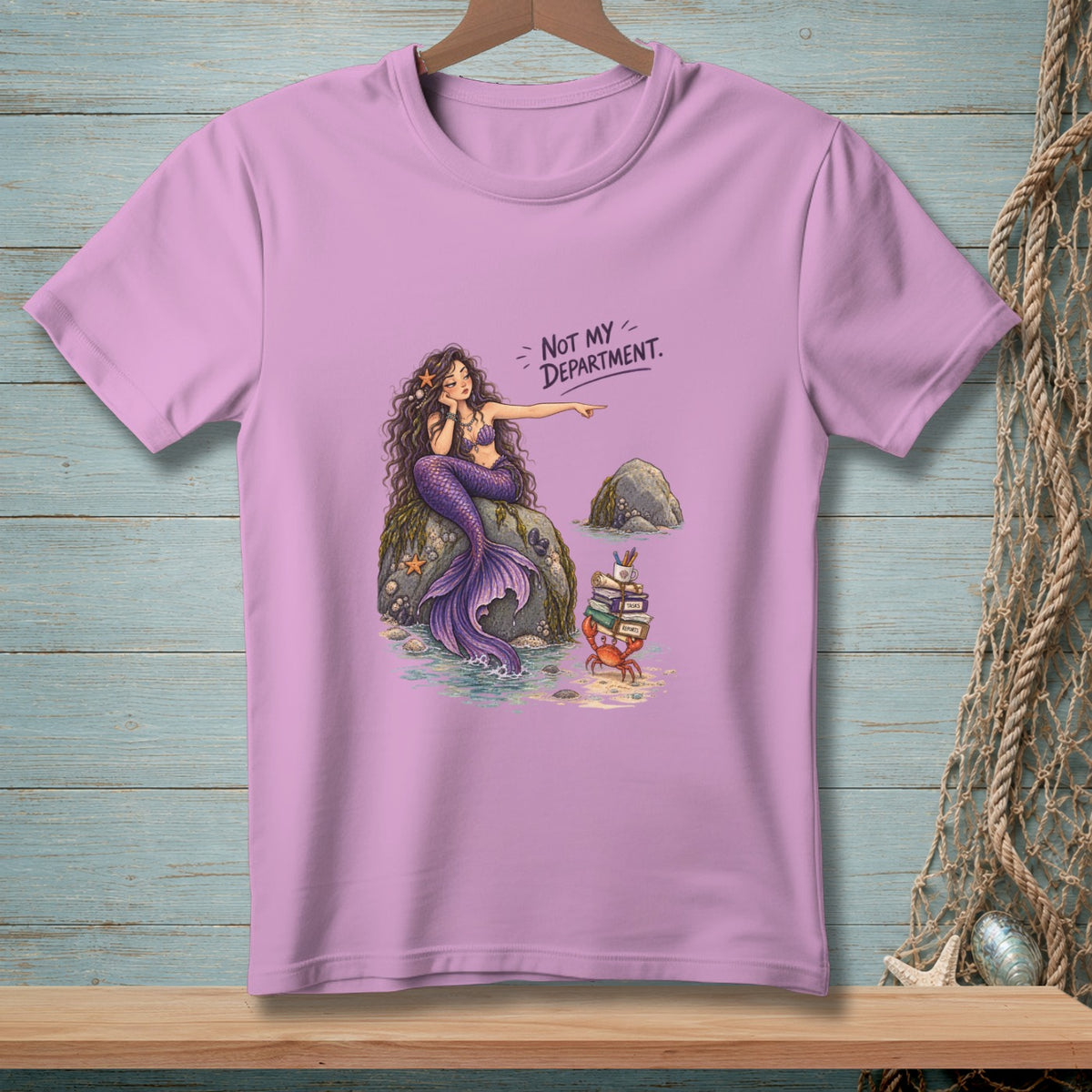 Mermaid on rock points at crab with books and art supplies, text "Not My Department."