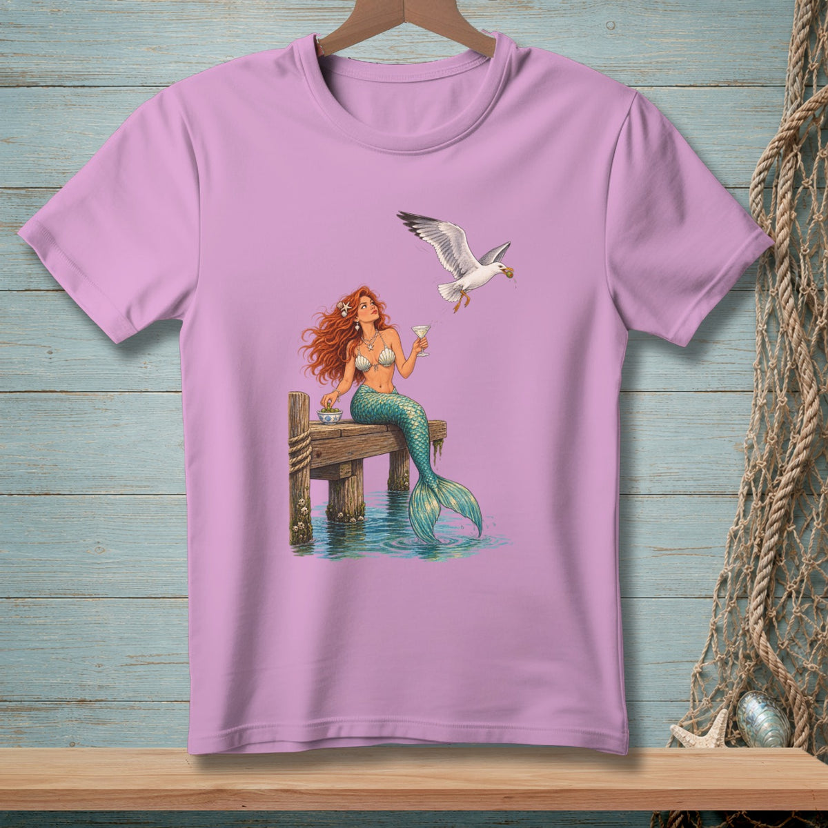 Mermaid on a pier with a seagull stealing her food.