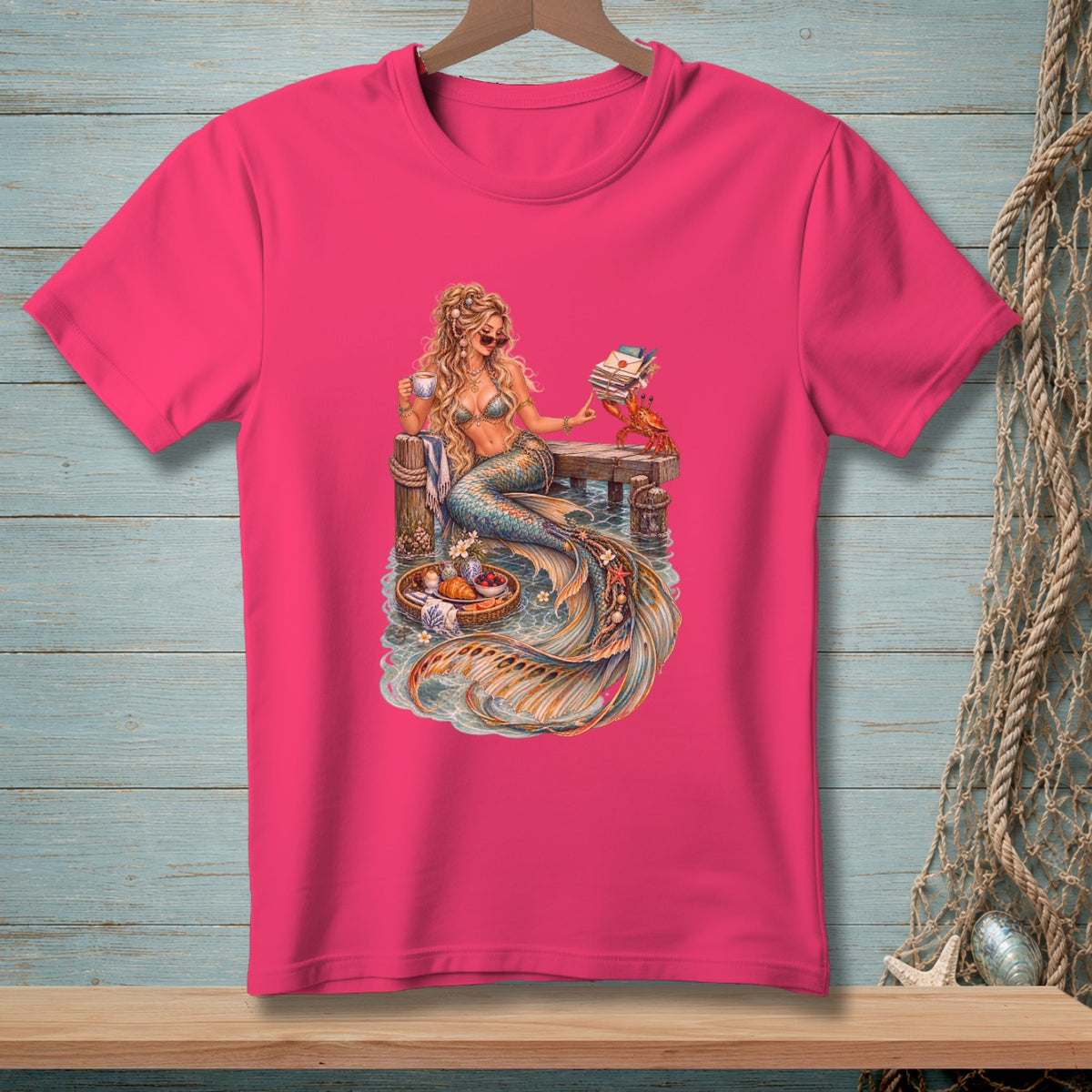 Illustration of a mermaid reading and drinking coffee on a dock with a crab.