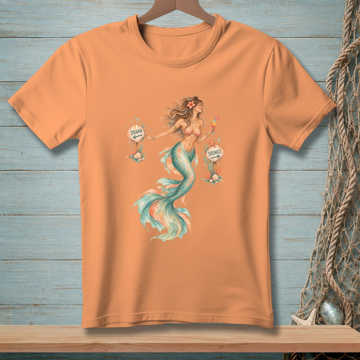 Peach t-shirt with watercolor mermaid graphic and signs for "Drama" and "Drinks".