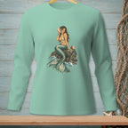 Mermaid holding a seashell sitting on a rock with waves around her.