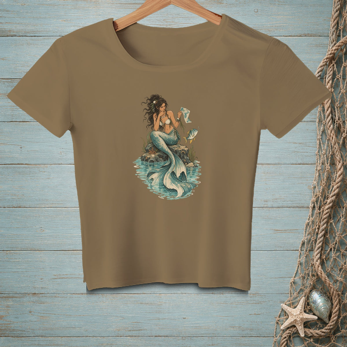 Illustration of a mermaid sitting on rocks in water, holding a map.