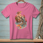 Pink t-shirt with a detailed illustration of a mermaid on a rock with crabs and starfish.