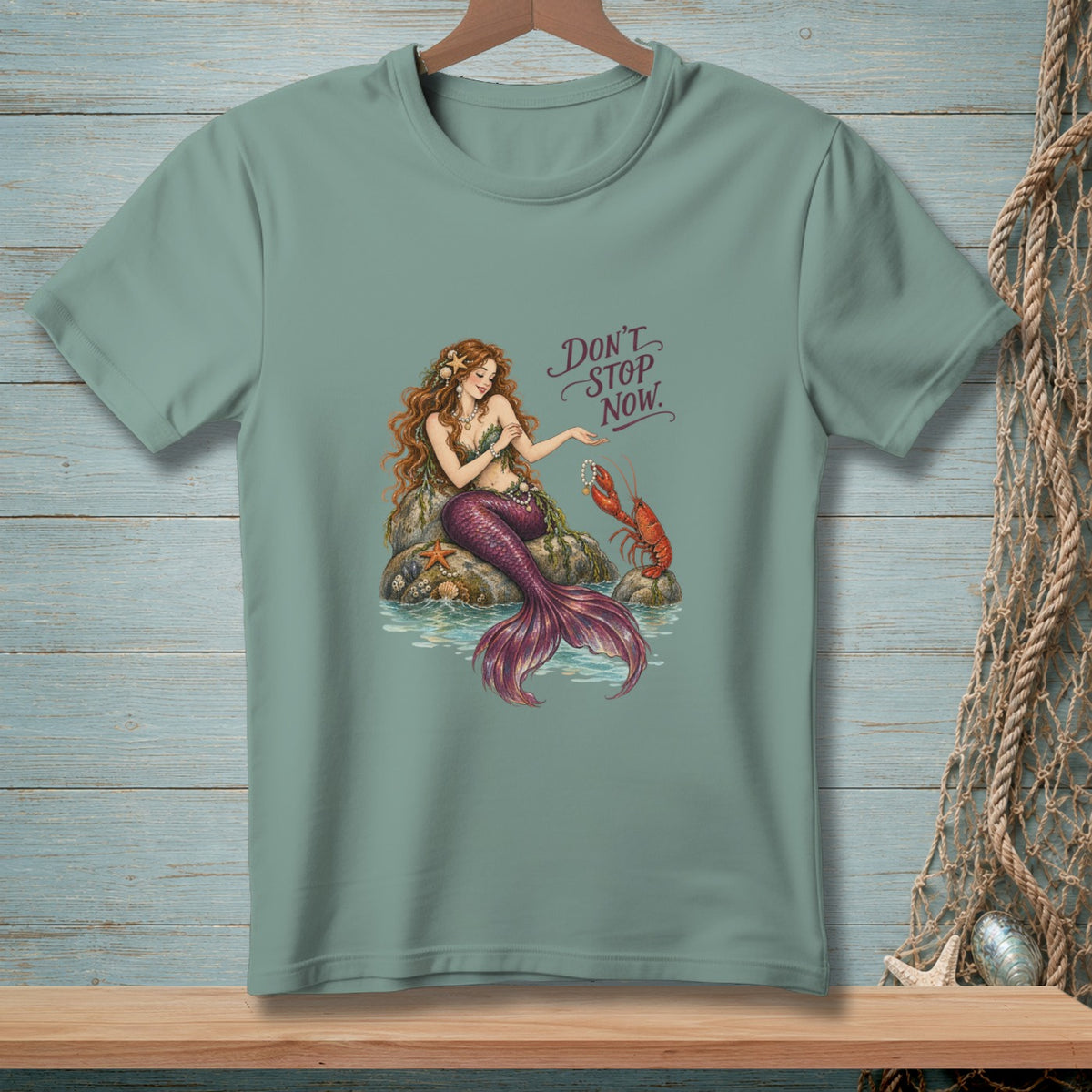 Mermaid with lobster on rock, text "Don't Stop Now".