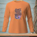 Orange long-sleeve shirt with "Don't Test the Waters" and a mermaid tail graphic.