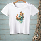 White t-shirt with a graphic of a mermaid holding cocktails on a rock with a crab.