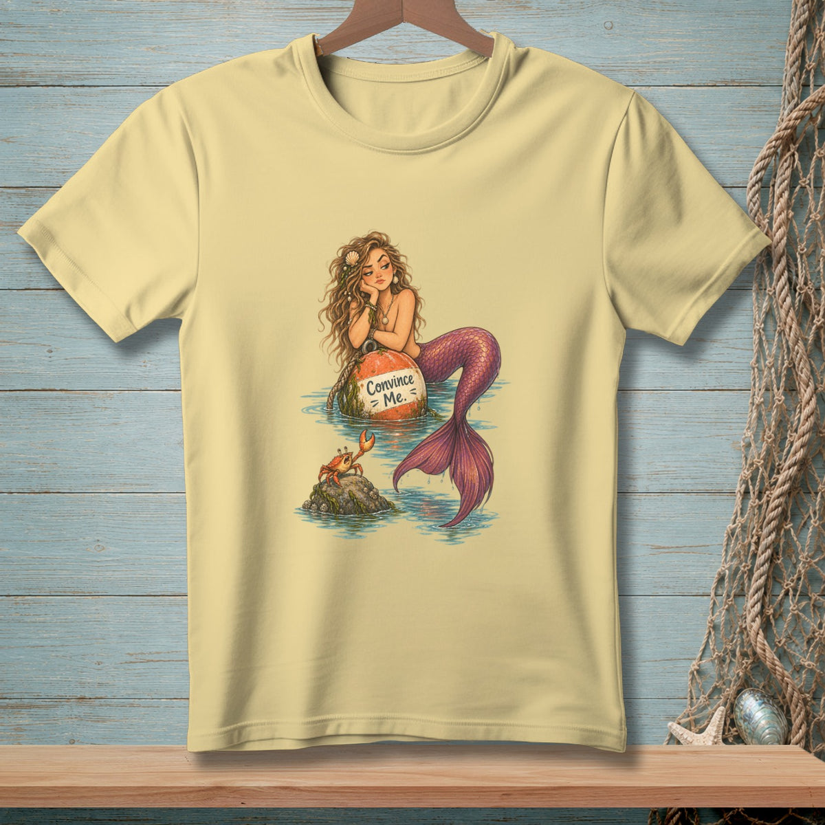 T-shirt with a mermaid sitting on a buoy that says "Convince Me."