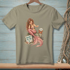 Mermaid sitting on a rock with a crab and a sign that reads "Blame the Tail".