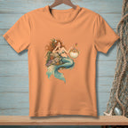 Peach t-shirt featuring a mermaid with a cocktail and a pufferfish.