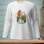 White long-sleeve shirt with a mermaid combing her hair on a pier with a crab.