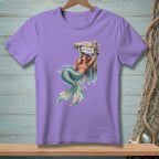 Purple t-shirt with a mermaid lounging by a wooden post with "ATTITUDE" text.