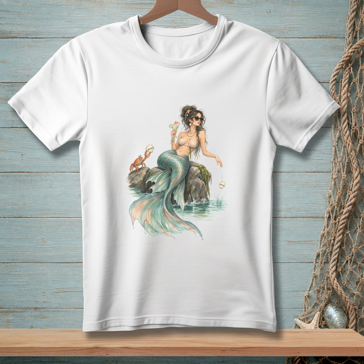 Mermaid with sunglasses and cocktail sits on rocks with a crab and shells.