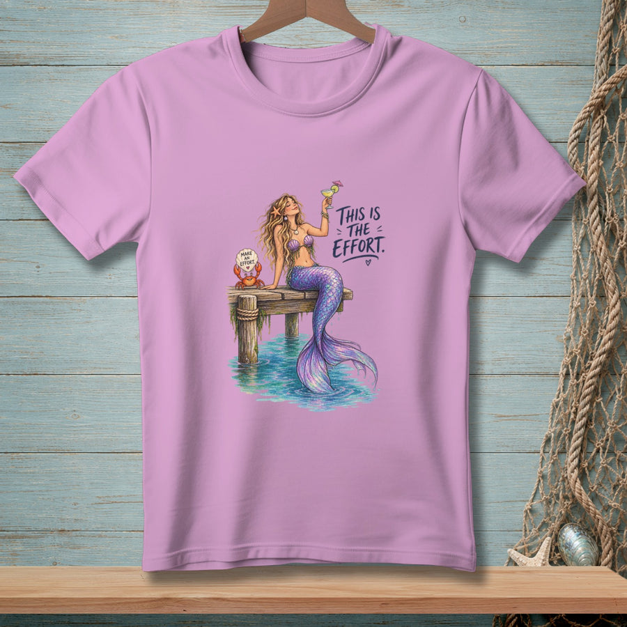 Mermaid on pier with drink, crab with "Make an effort" sign. Text "This is the effort."