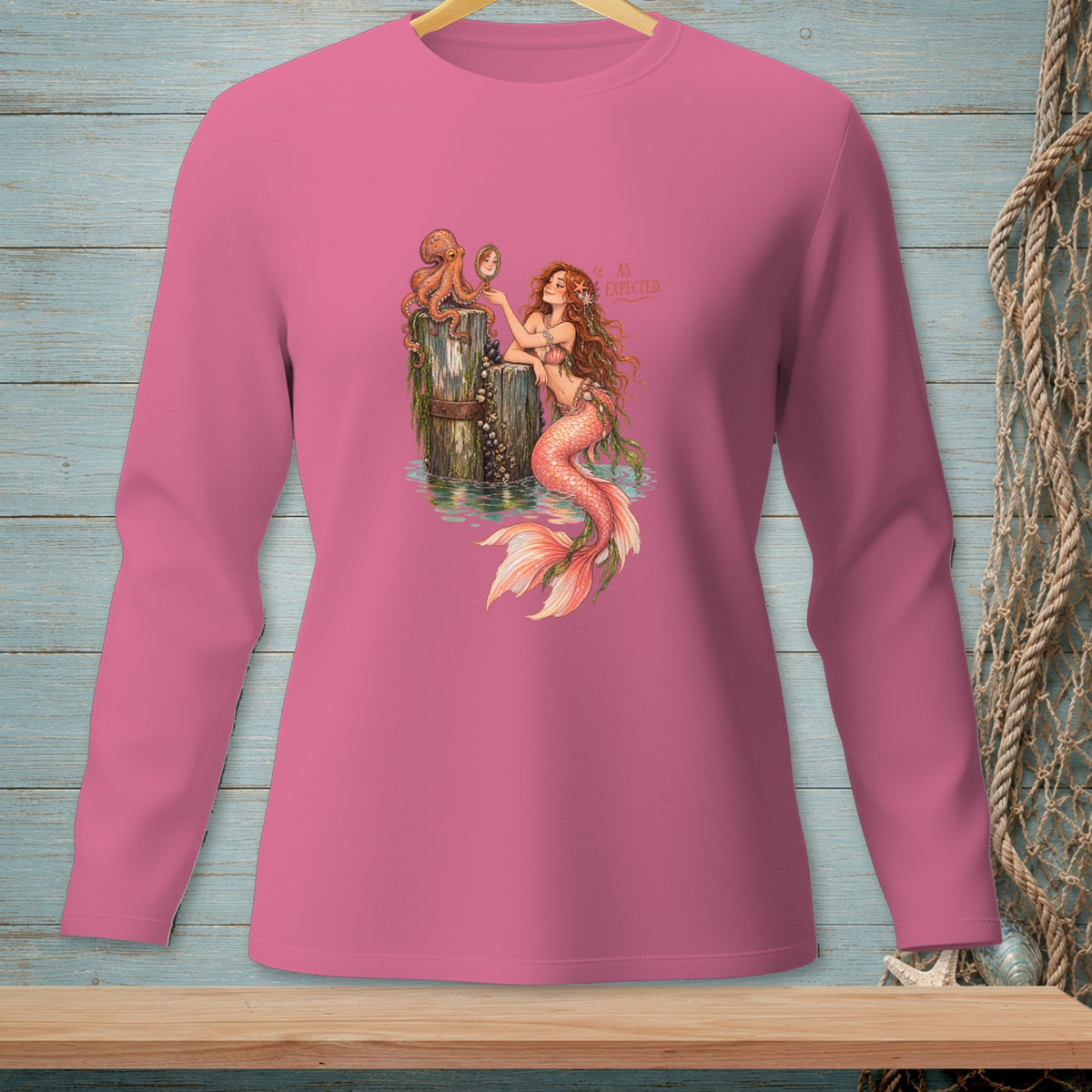 Pink long-sleeved shirt with a mermaid, octopus, and "AS EXPECTED" text.