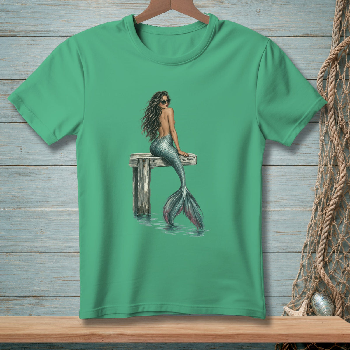 Green t-shirt with a graphic of a mermaid wearing sunglasses sitting on a dock with the text "YOU AGAIN?".