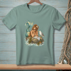 T-shirt graphic of a mermaid with a seagull and a plate of food on a rock.
