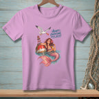Pink t-shirt graphic of mermaid on buoy with seagull, reading "Adapt. Overcome. Order Another."